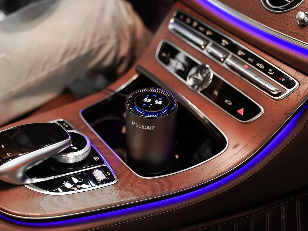 A cup-holder air purifier in a car's centre console