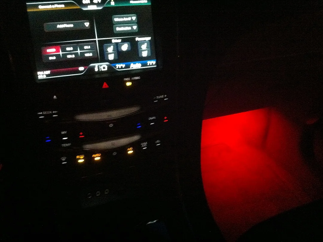 A car's footwell lit by a soft LED